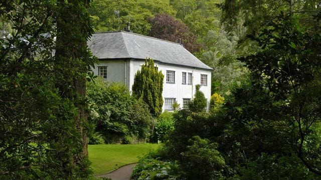 White Cottage seen through the trees